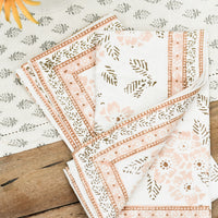 3: A pair of cotton napkins with peach and brown floral print.
