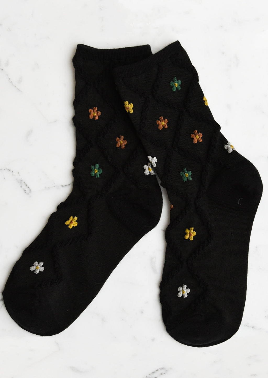 Black Multi: A pair of black socks with diamond pattern and florals.