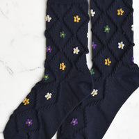 Navy Multi: A pair of navy socks with diamond pattern and florals.