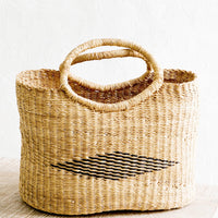 1: Woven tote bag made from natural elephant grass. Black diamond pattern woven at center, two handles at top.