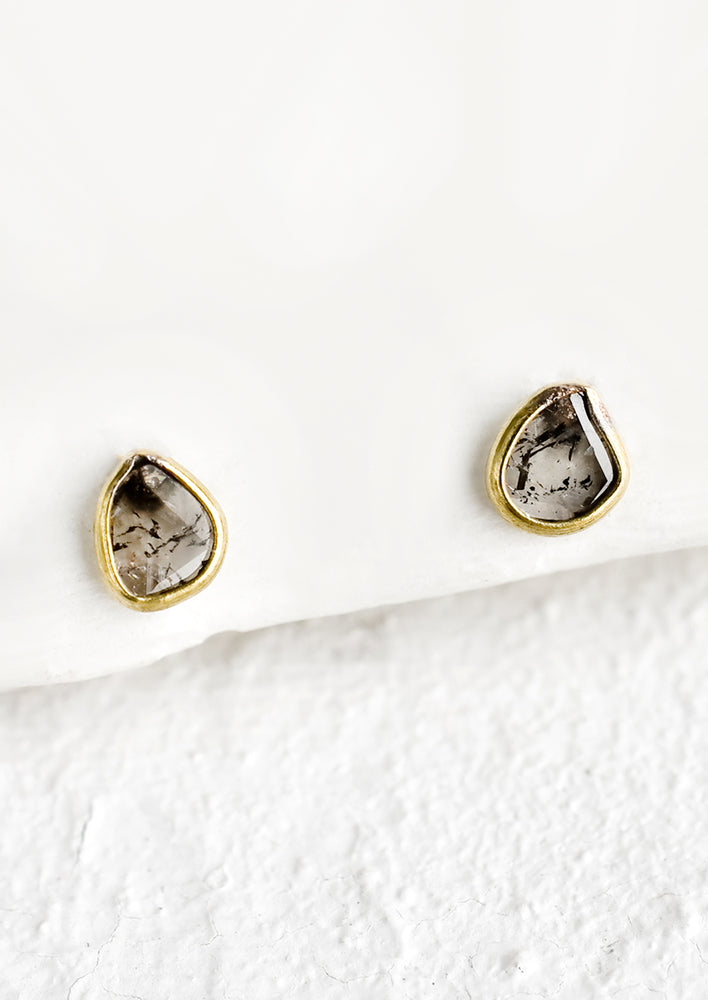 1: Organically shaped stud earrings with small diamond slice surrounded by brass metal trim