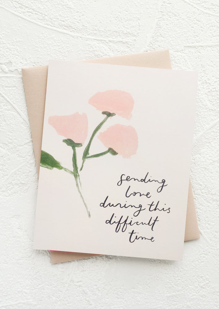 A greeting card with text reading "Sending love during this difficult time".