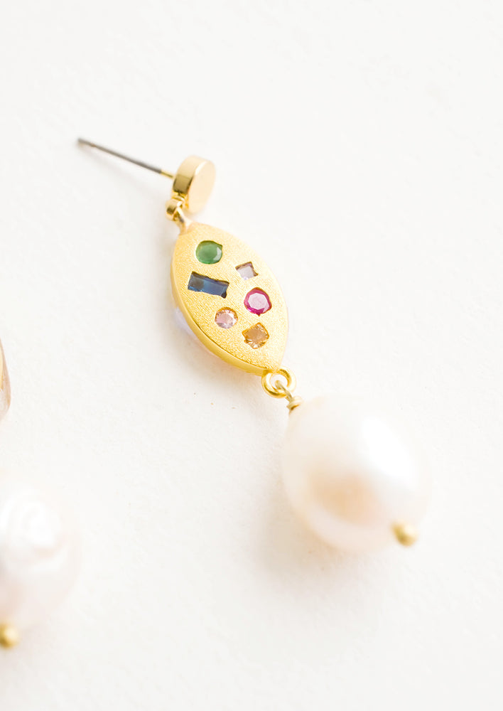 Dangle earrings with round gold post, gold baguette middle with embedded gemstones, pearl bead bottom