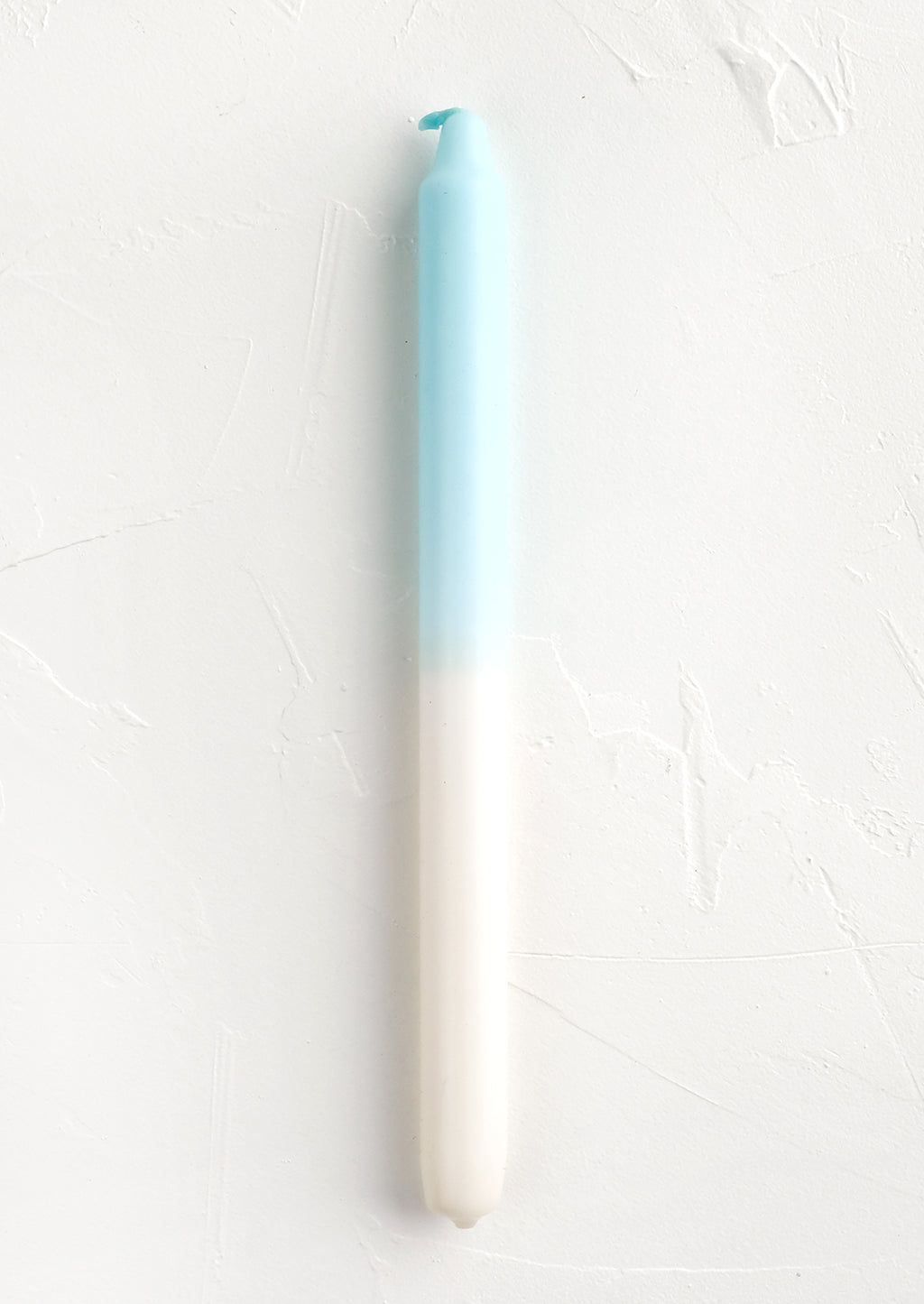 Ivory / Sky Blue: A straight taper candle in blue and white.