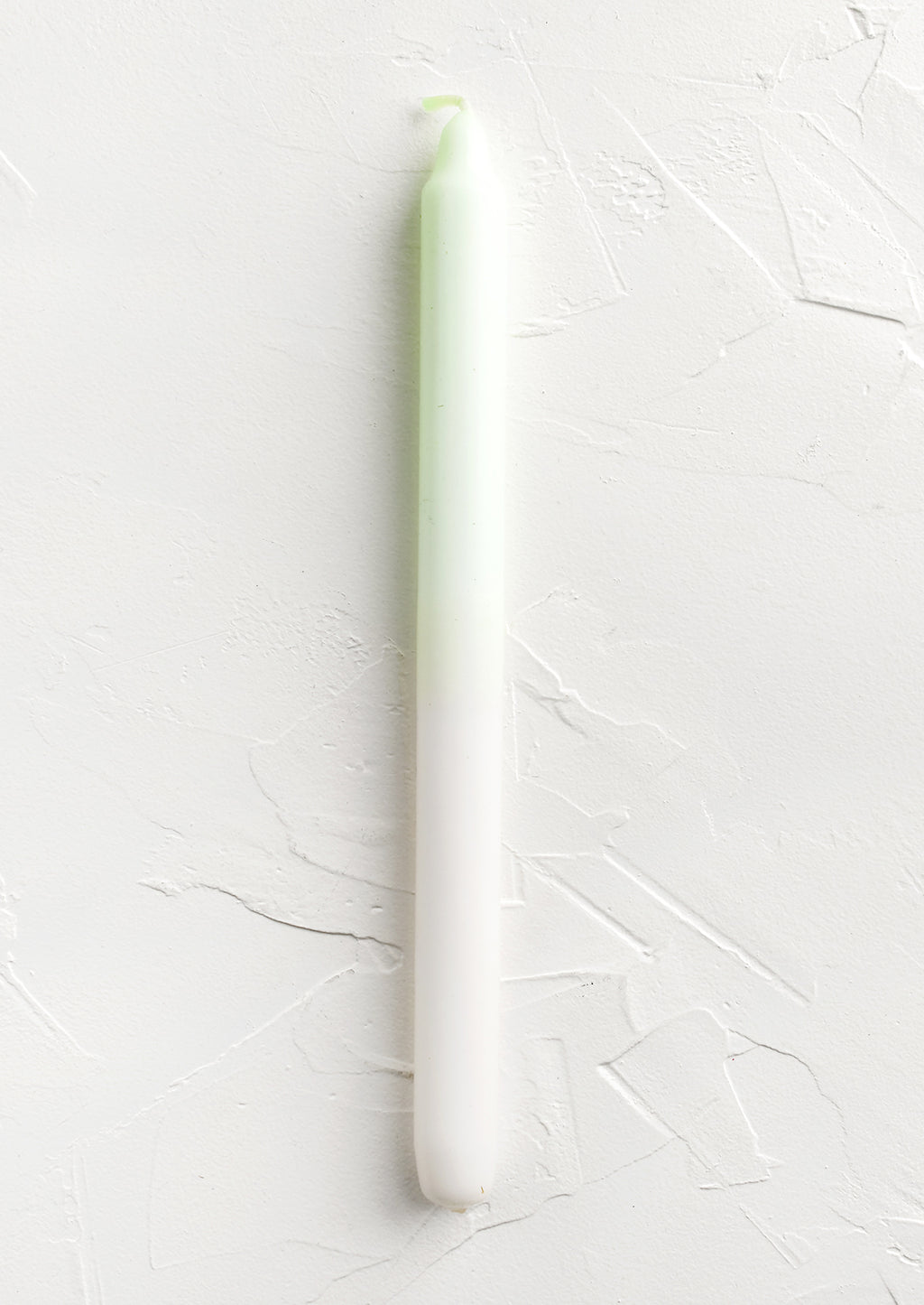 Ivory / Lime: A straight taper candle in lime and white.