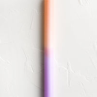 Peach / Lilac: A straight taper candle in peach and lilac.