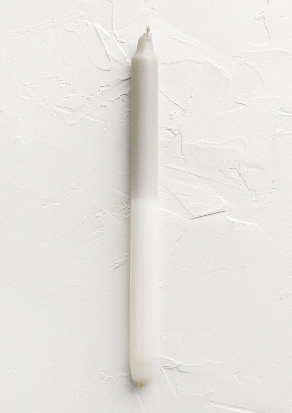 Ivory / Taupe: A straight taper candle in taupe and white.