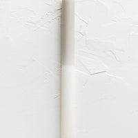 Ivory / Taupe: A straight taper candle in taupe and white.