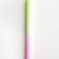Neon Yellow / Pink: A straight taper candle in neon yellow and pink.