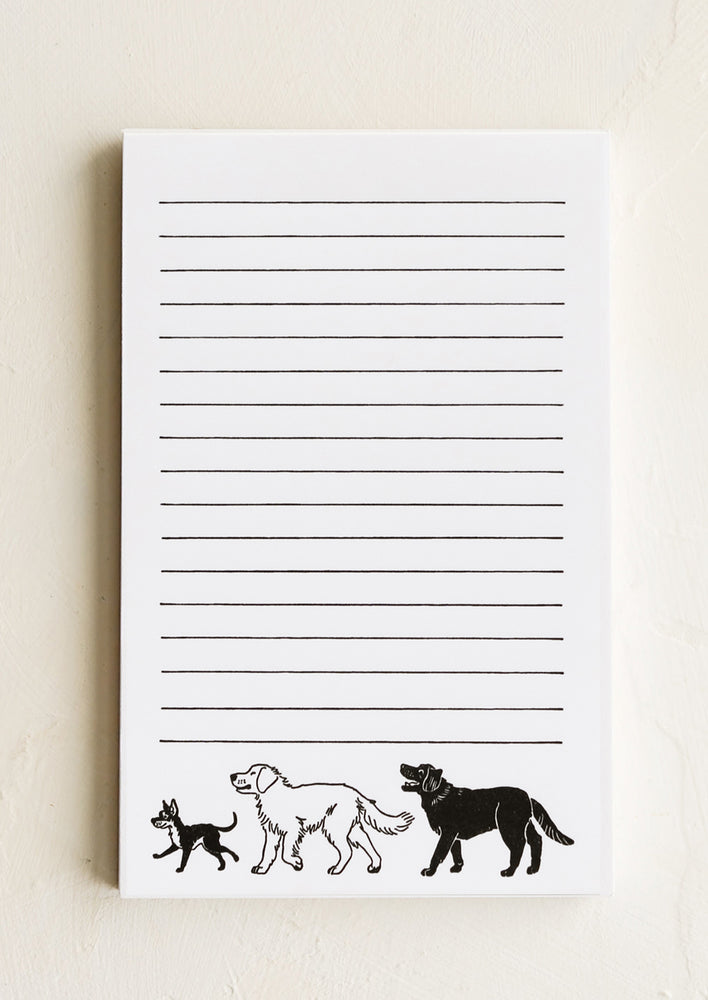 A ruled notepad with black and white dog print.