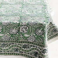 2: A block printed tablecloth with traditional print in blue and green shades.