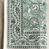 1: A block printed tablecloth with traditional print in blue and green shades.