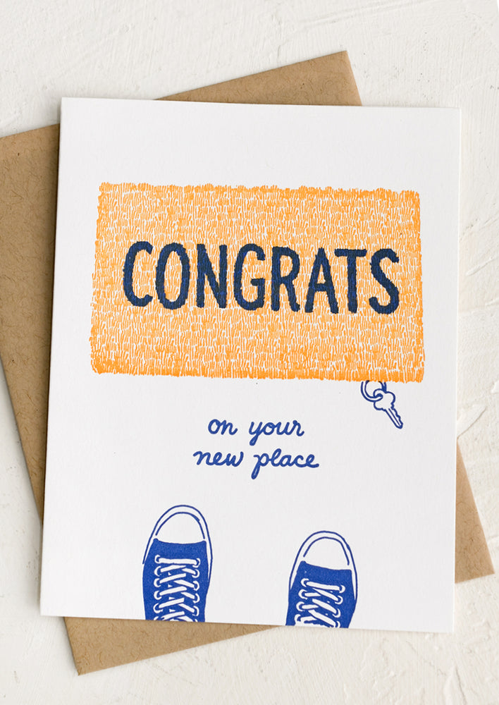 A card with image of doormat reading "CONGRATS on your new place".