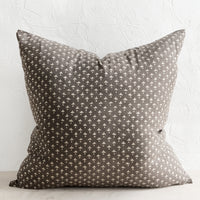 2: A square block printed throw pillow in dark grey with white dot-cross motif.