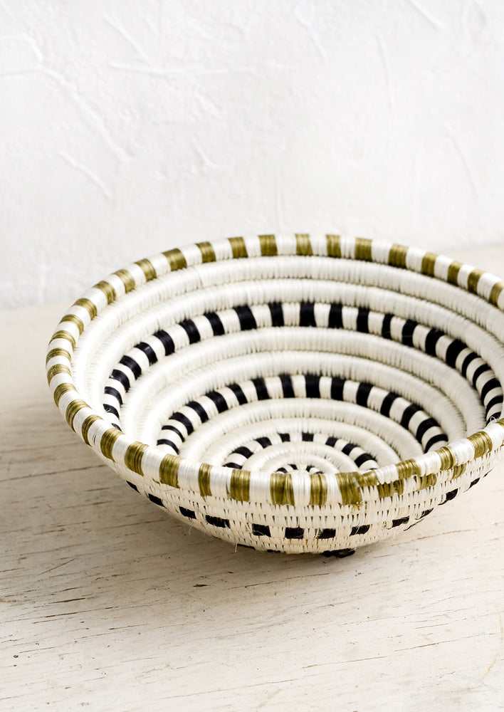 A sweetgrass basket in black and white dash pattern.