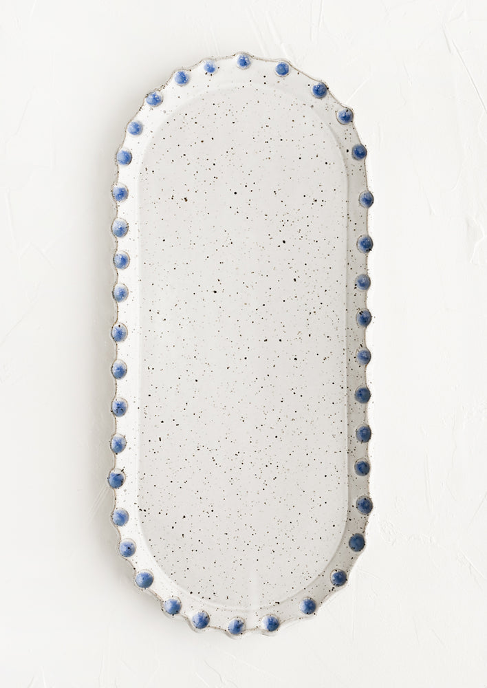 Glossy White Speckle / Blue: An oblong, oval shaped ceramic platter with blue dot imprint border.