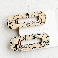 Cream / Black: A pair of open rectangle shaped acetate hair clips in tan and black marble.