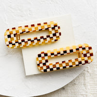 Basketweave Check: A pair of open rectangle shaped acetate hair clips in brown basketweave checker print.