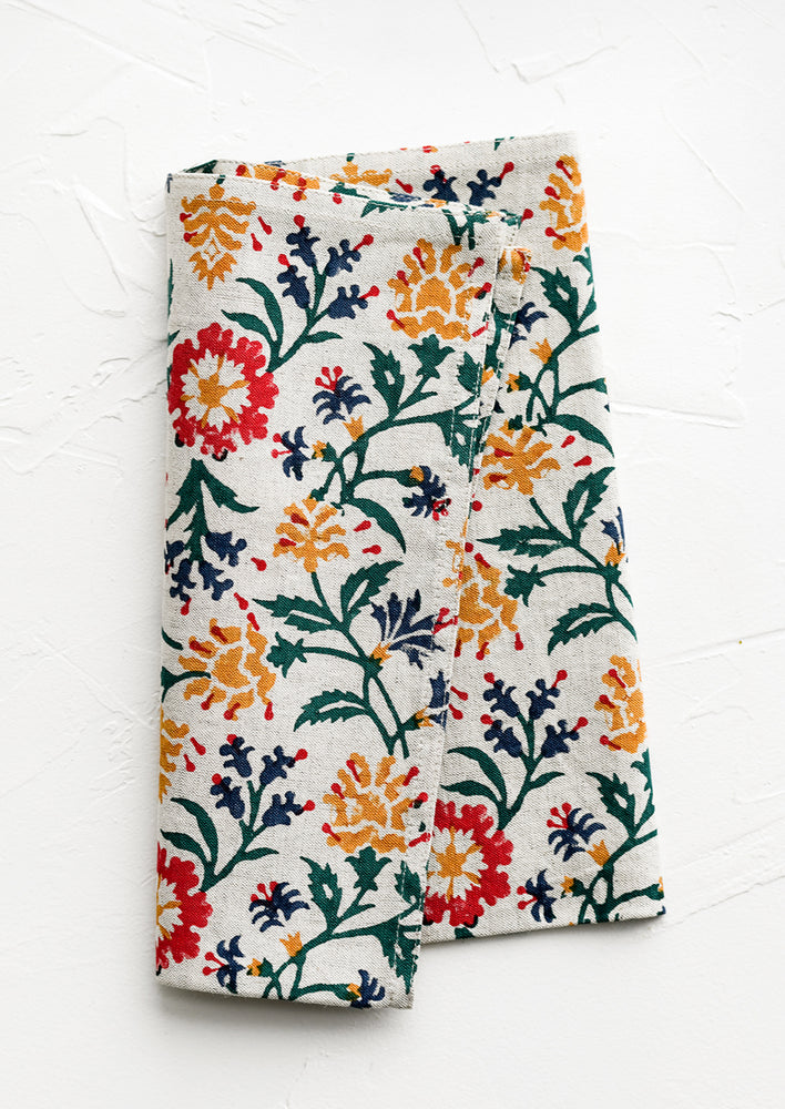 1: A linen napkin with primary color floral print.