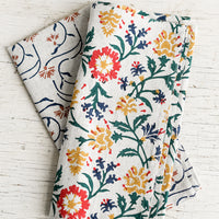2: A linen napkin with primary color floral print.