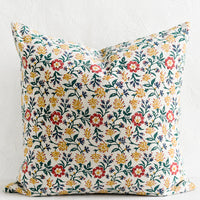 1: A block printed pillow in green, red, blue and yellow floral print.