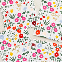 1: A set of thank you cards with vibrant floral pattern and gold "Thank You" text at center.