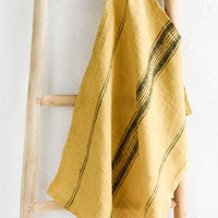 Saffron: A woven tea towel in yellow with black stripe.