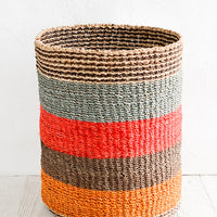 Large / Red Multi: A large woven straw storage basket in a red, orange and brown stripe print.