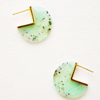 1: Three quarter disc shaped earrings of a semi-translucent blue-green gemstone speckled with brown flecks with gold hardware and post back.