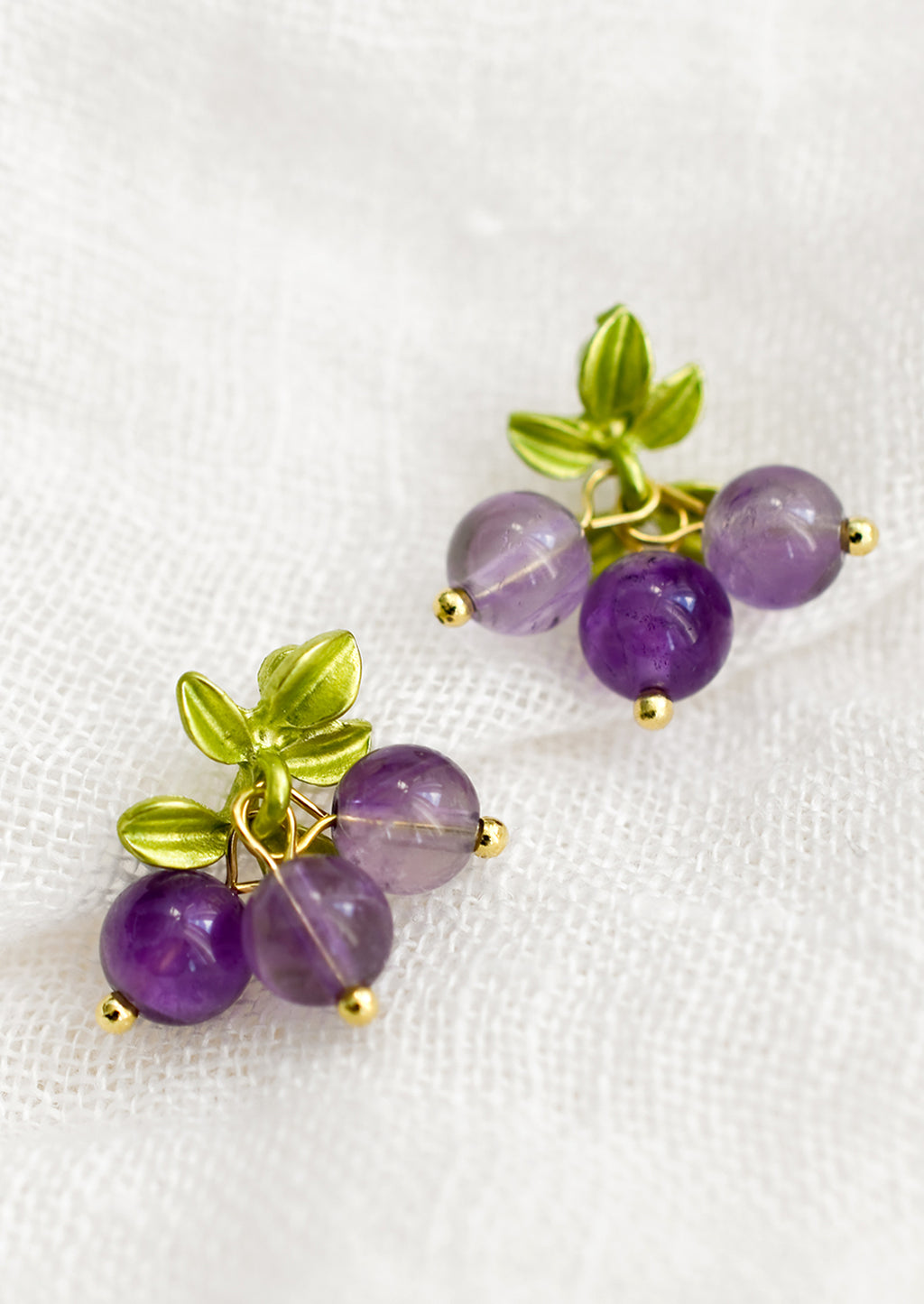 Grape: A pair of earrings made to resemble grapes, made with round amethyst beads.