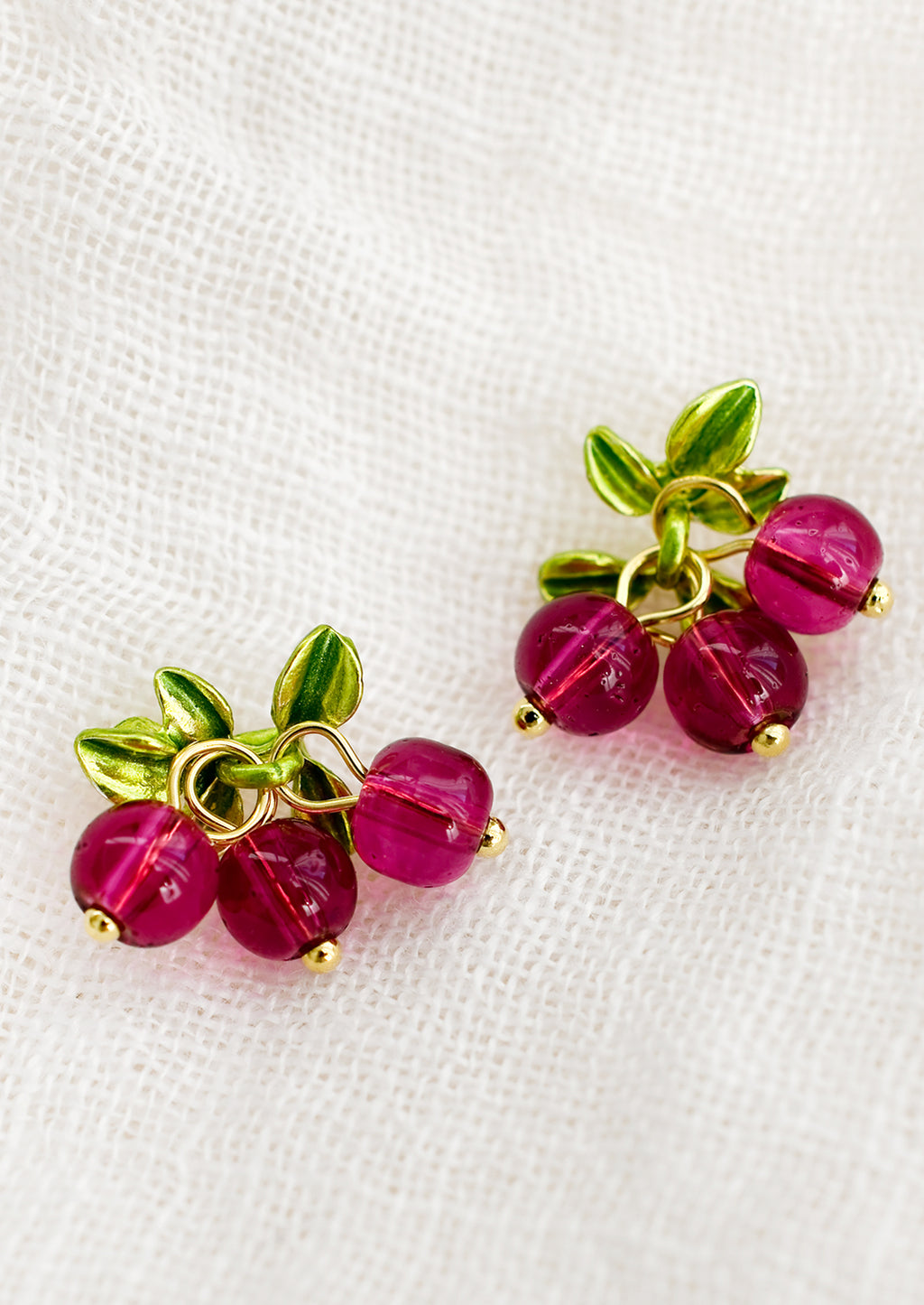 Cranberry: A pair of earrings made to resemble cranberries, made with round pink beads.