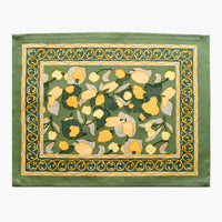 2: A block printed placemat in green and yellow fruit print.