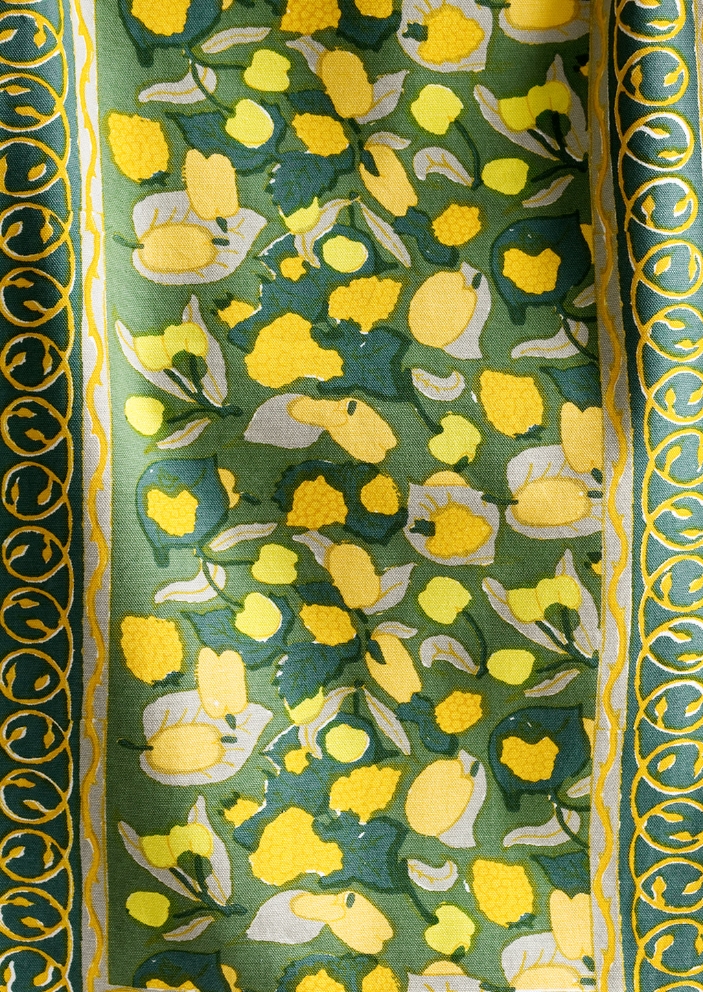 2: A block printed table runner in green and yellow print.