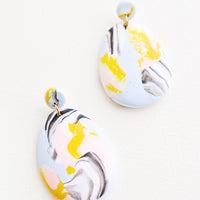 Blue Mist: Blue, pink, yellow, and black marbled clay earrings, with a larger oval dangling from a small circle.