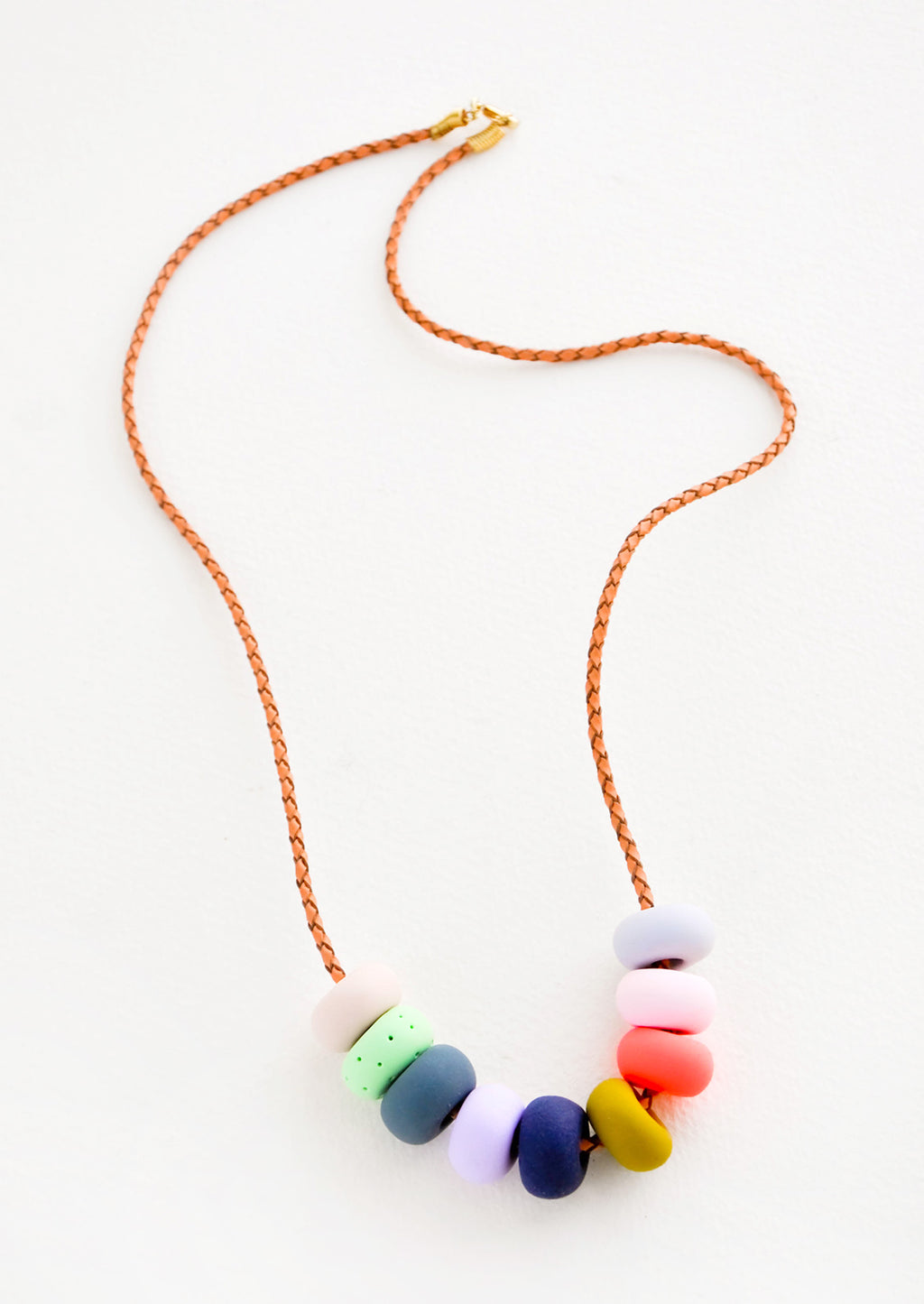 Summer Fair: Woven leather cord necklace with gold clasp and rounded clay beads red, blue, lime green and mustard yellow.