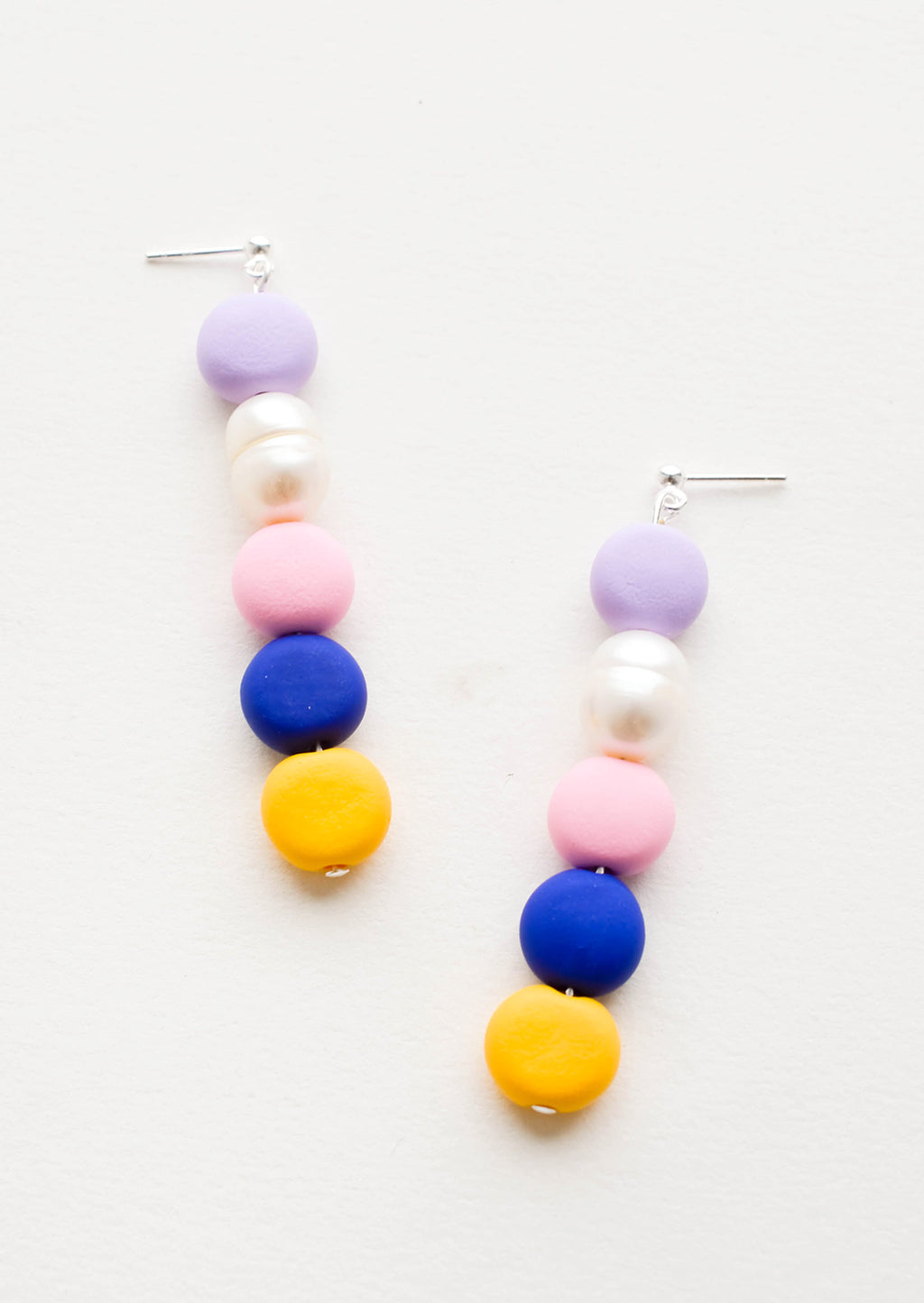 Navy Multi: Earrings with colorful clay beads stacked in a row mixed with one pearl bead