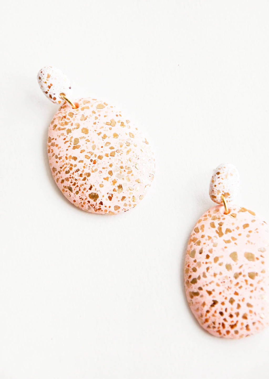 Blush / White: Dangling glitter covered earrings, with a blush pink larger oval dangling from a small white bead.
