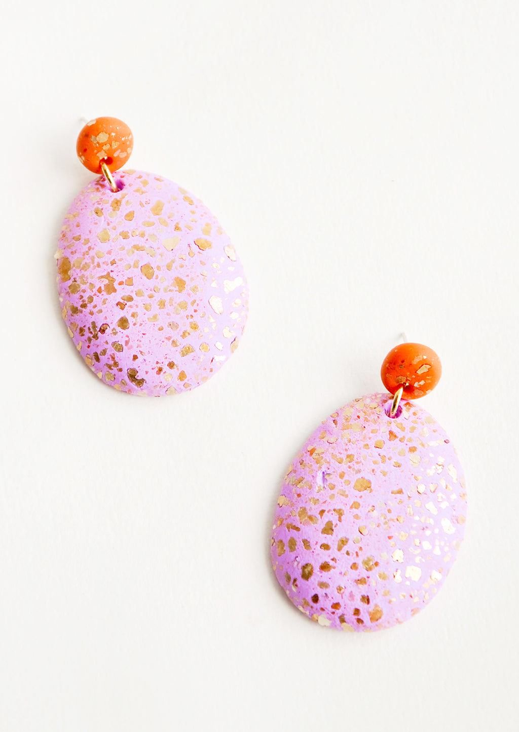 Orchid / Terracotta: Dangling glitter covered earrings, with a pink larger oval dangling from a small red bead.