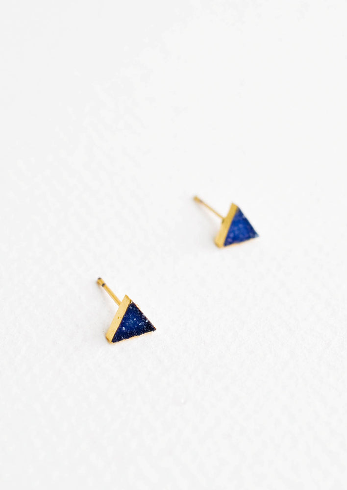 1: Triangular stud earrings of blue textured stones in gold setting.
