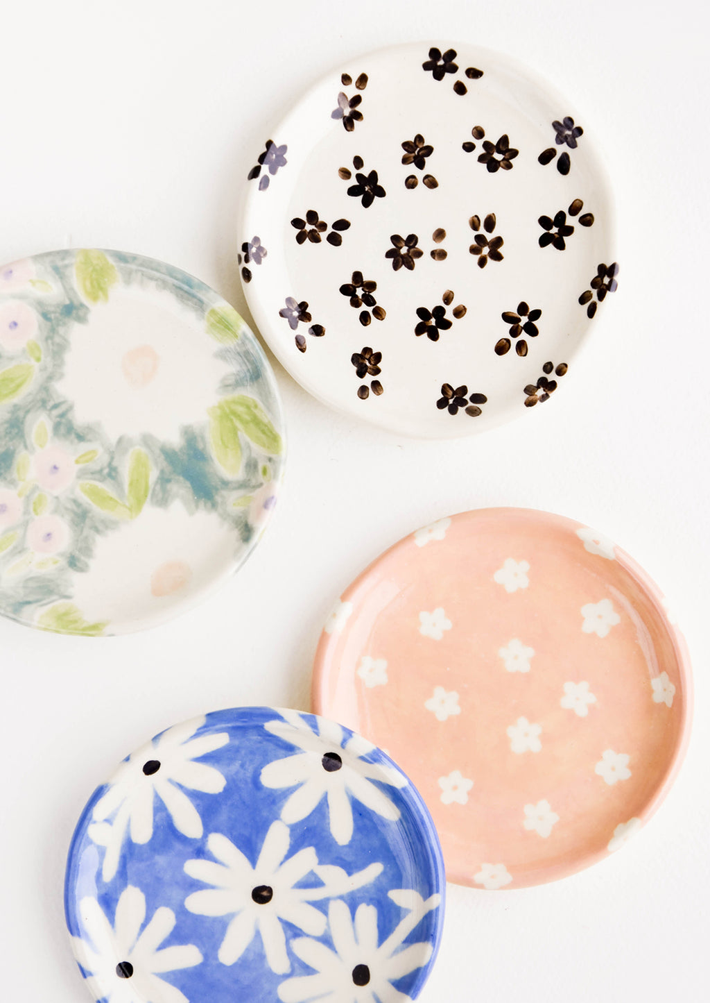 3: Round ceramic jewelry dishes in a mix of floral patterns