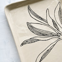 6: Black etched botanical detailing on a ceramic tray.