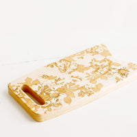 2: Flag shaped maplewood cutting board with handle cutout, lasercut floral pattern