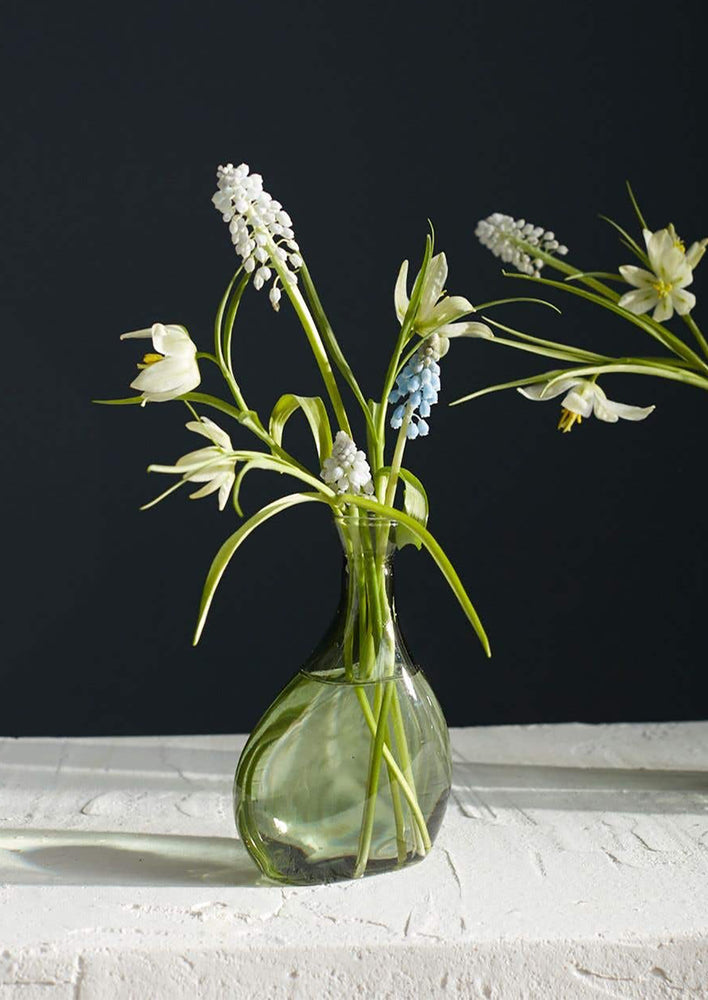 Medium: A tall, asymmetric glass vase in translucent green glass.