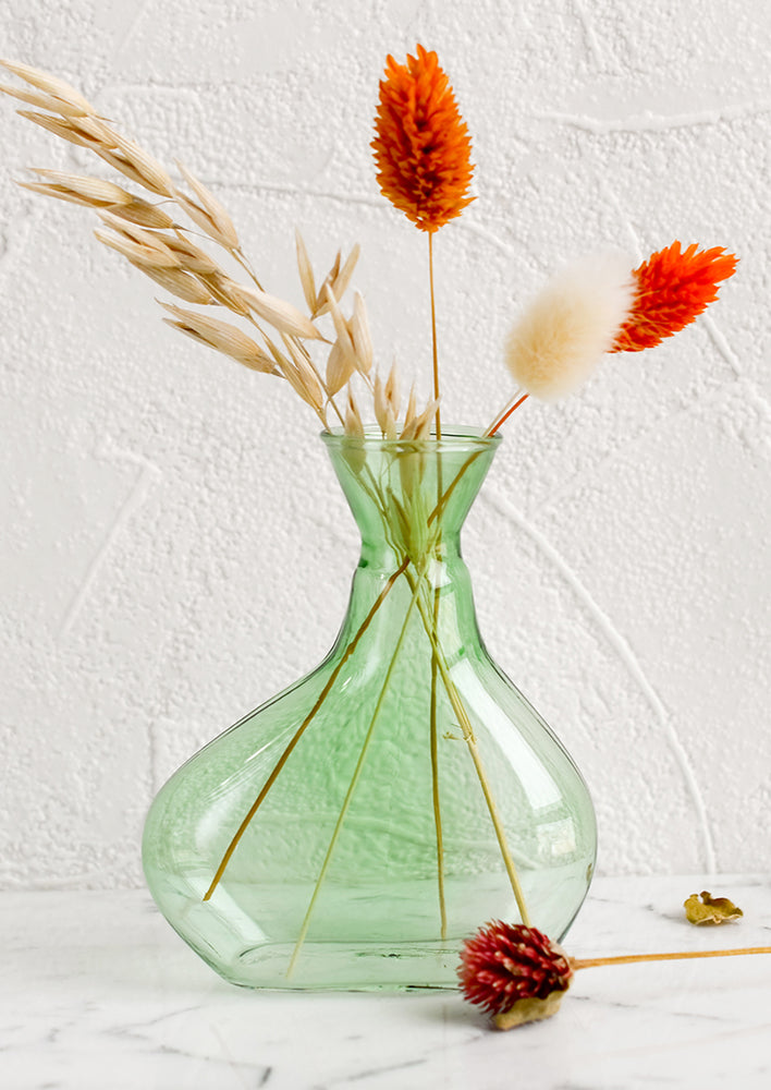 Small: A short, asymmetric glass vase in translucent green glass.