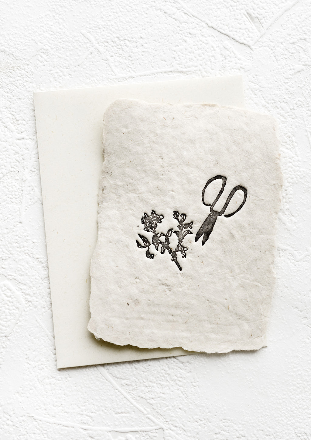 1: A greeting card made from handmade paper with a letterpress printed image of garden shears.