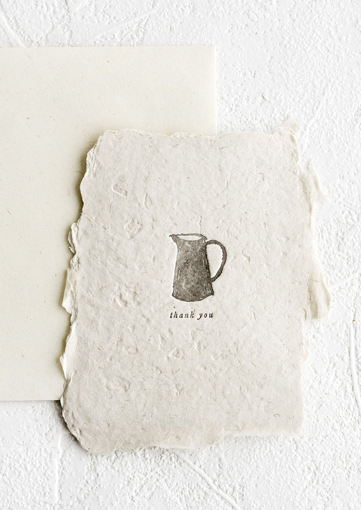 A notecard made from deckled edge handmade paper with image of a pitcher.