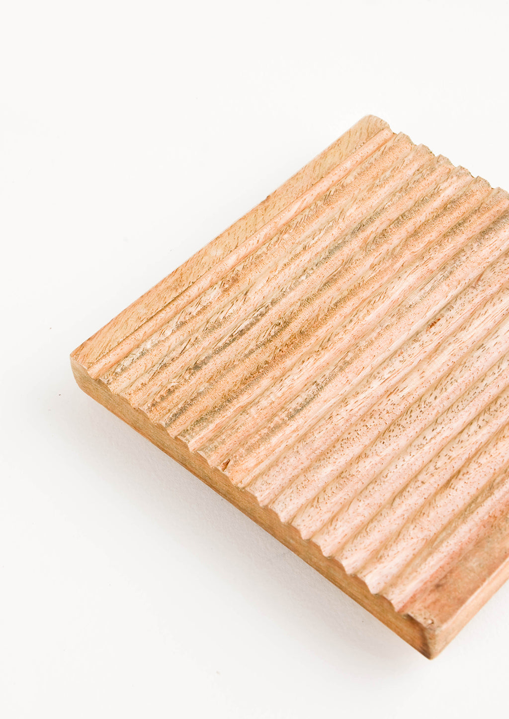 2: Wooden trivet in warm, medium-colored wood with grooved construction and square shape