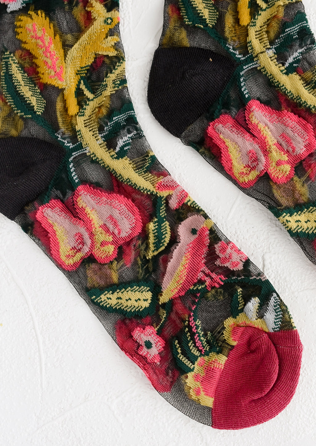 2: A pair of sheer black socks with multicolor creature print.
