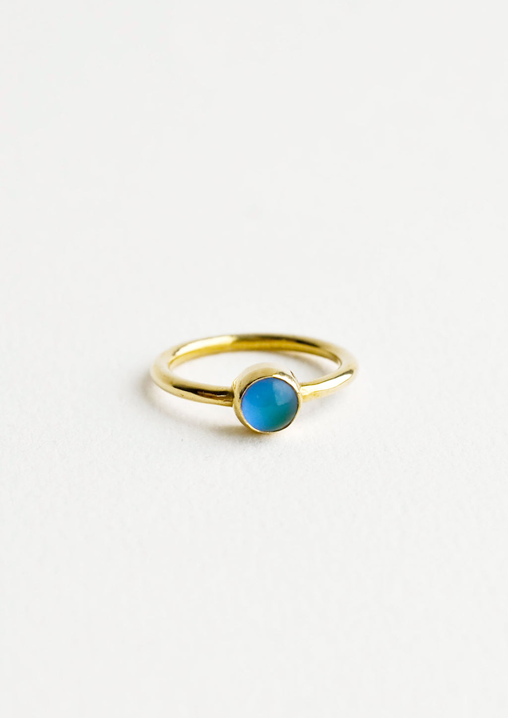 1: A gold ring with a round blue stone.