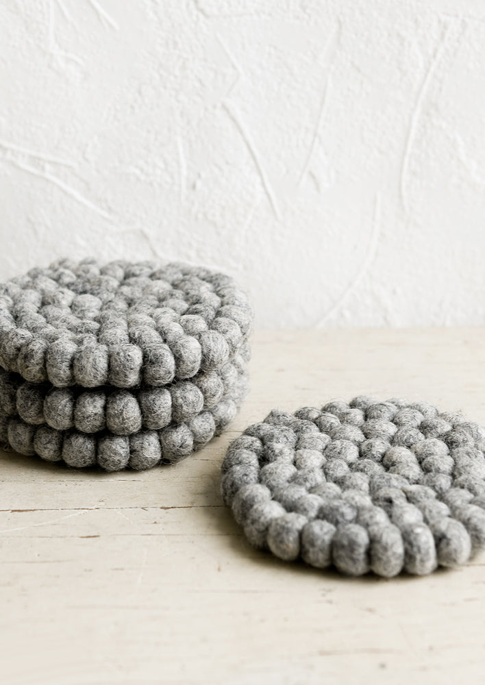 Heather Grey: A set of round felted wool coasters in heather grey.
